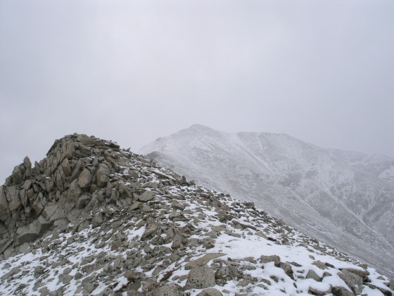 The storm envelopes us and the summit