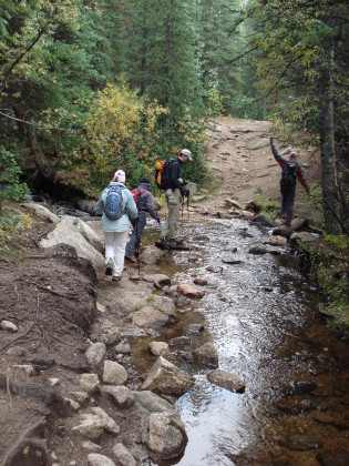 Tracy, Shari, Lonny, and Brad (nearly falling over) crossing a stream