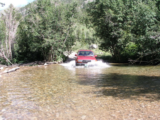 The Land Cruiser plunges into the first stream crossing