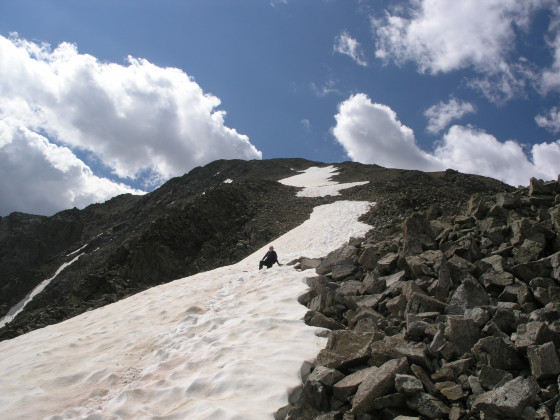 A small snowfield offers a reprieve from boulder-hopping